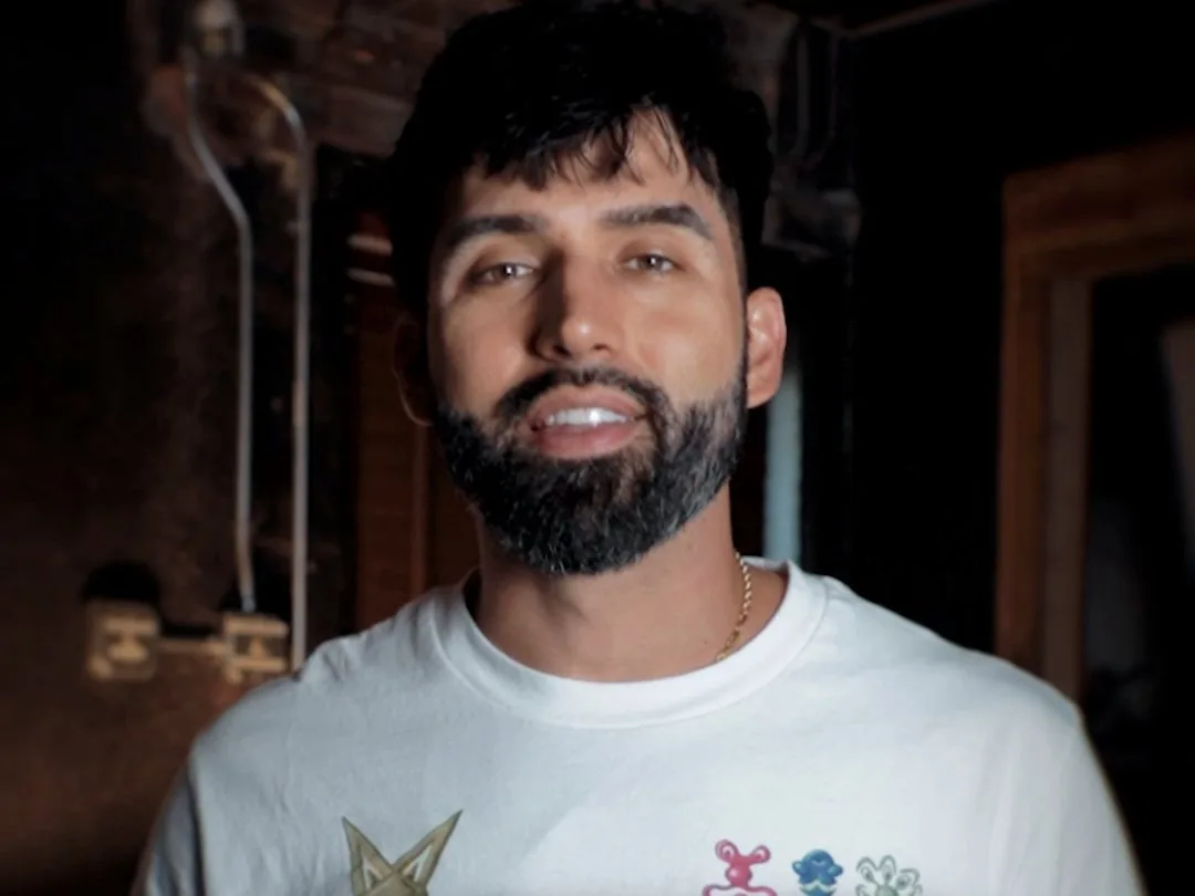 Michael Preston smiling in a white tee